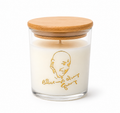 Guruji's Blessing candle lit, close-up of gold engraved design on glass jar